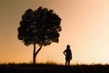 Woman standing under a tree.