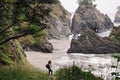 Woman standing with a view to a secret beach in Oregon coast. Hiking at the Pacific Northwest Royalty Free Stock Photo