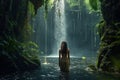 a woman standing in the water near a waterfall