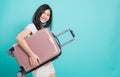 Woman standing wear white t-shirt, holidays travel concept, her hugging suitcase Royalty Free Stock Photo