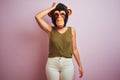 Woman standing wearing t-shirt and monkey mask