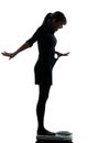 Woman standing on weight scale happy silhouette Royalty Free Stock Photo