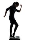 Woman standing on weight scale happy silhouette Royalty Free Stock Photo