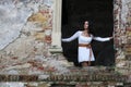 Woman standing in window frame