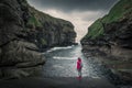 Woman in the gorge in the village of Gjogv on Eysturoy, Faroe Islands