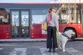 Woman stands with a dog on a bus station Royalty Free Stock Photo