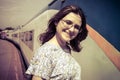 A girl stands in front of the train. Woman stands on the platform and smiling. Arrival of the train at the station Royalty Free Stock Photo