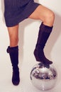 Woman stands on glitterball Royalty Free Stock Photo