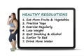 Woman stands with healthy resolutions on board