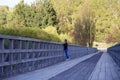 A woman stands on the historic Lower Shotover Bridge in Queenstown, New Zealand Royalty Free Stock Photo