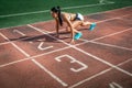 Woman stands in a low start for running Royalty Free Stock Photo