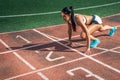 Woman stands in a low start for running Royalty Free Stock Photo