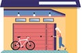Woman stands near garage with opening door and bicycle. Storage space for bike, room for transport Royalty Free Stock Photo