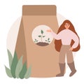 woman stands and points with her hand at the fertilizer of plants, soil for plants.
