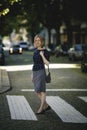 A woman stands on a quiet street. Royalty Free Stock Photo