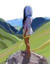 Woman stands on a rock and looks at a mountain valley