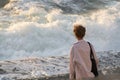 Woman stands by stormy sea Royalty Free Stock Photo
