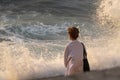 Woman stands by stormy sea Royalty Free Stock Photo