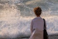 Woman stands by stormy sea Royalty Free Stock Photo