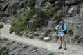 Woman Stands On Trail and Present Orange Water Bottle