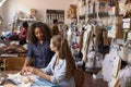 Woman stands training an apprentice at clothes design studio Royalty Free Stock Photo