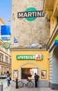 Woman stands at a wall and watches posters for female hair care