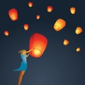 Woman start a red Chinese sky lantern to the sky Royalty Free Stock Photo