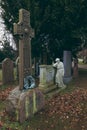 Woman statue leaning on tomb in Dean Cemetery, Edinburgh