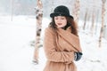 Woman staying warm during a snow storm Royalty Free Stock Photo