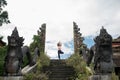 Woman staying in yoge pose at old stone stairs temple entrance