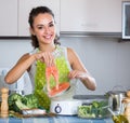 Woman steaming salmon and vegetables Royalty Free Stock Photo