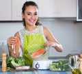 Woman steaming salmon and vegetables Royalty Free Stock Photo