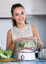 Woman steaming salmon and vegetables Royalty Free Stock Photo