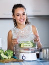 Woman steaming salmon and vegetables Royalty Free Stock Photo