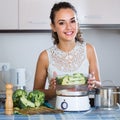 Woman steaming salmon and vegetables Royalty Free Stock Photo