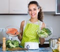 Woman steaming salmon and vegetables Royalty Free Stock Photo