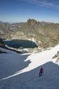 Woman On Steep Snowfield In The Mountains