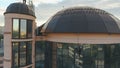 Woman steeplejack hangs near the business center