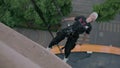 Woman steeplejack has a rest in the air