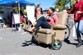 Woman Steers Oddball Furniture Piece On Wheels At Unique Fair Royalty Free Stock Photo