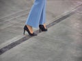 Woman step legs wearing black high heels shoes Royalty Free Stock Photo