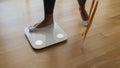 Woman step on Weighing Scale for Measuring Body Weight At Home. Royalty Free Stock Photo