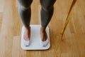 Woman step on Weighing Scale for Measuring Body Weight At Home. Royalty Free Stock Photo