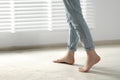 Woman stepping barefoot in room at home, closeup with space for text. Floor heating Royalty Free Stock Photo