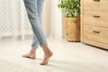 Woman stepping barefoot in room at home, closeup with space for text. Floor heating Royalty Free Stock Photo