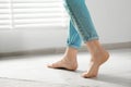 Woman stepping barefoot in room at home, closeup with space for text. Floor heating Royalty Free Stock Photo