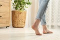 Woman stepping barefoot in room at home, closeup with space for text. Floor heating Royalty Free Stock Photo