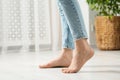 Woman stepping barefoot in room at home, closeup. Floor heating Royalty Free Stock Photo