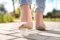 Woman stepping in chewing gum on sidewalk