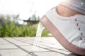 Woman stepping in chewing gum on sidewalk